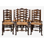 A set of seven oak ladderback dining chairs, early 20th century in the 18th century style, with rush