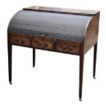 A George III mahogany tambour front desk, the fitted interior with eleven pigeonholes and five