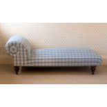 A Victorian day bed, the scroll bolster and stuffover seat reupholstered in blue check, raised on