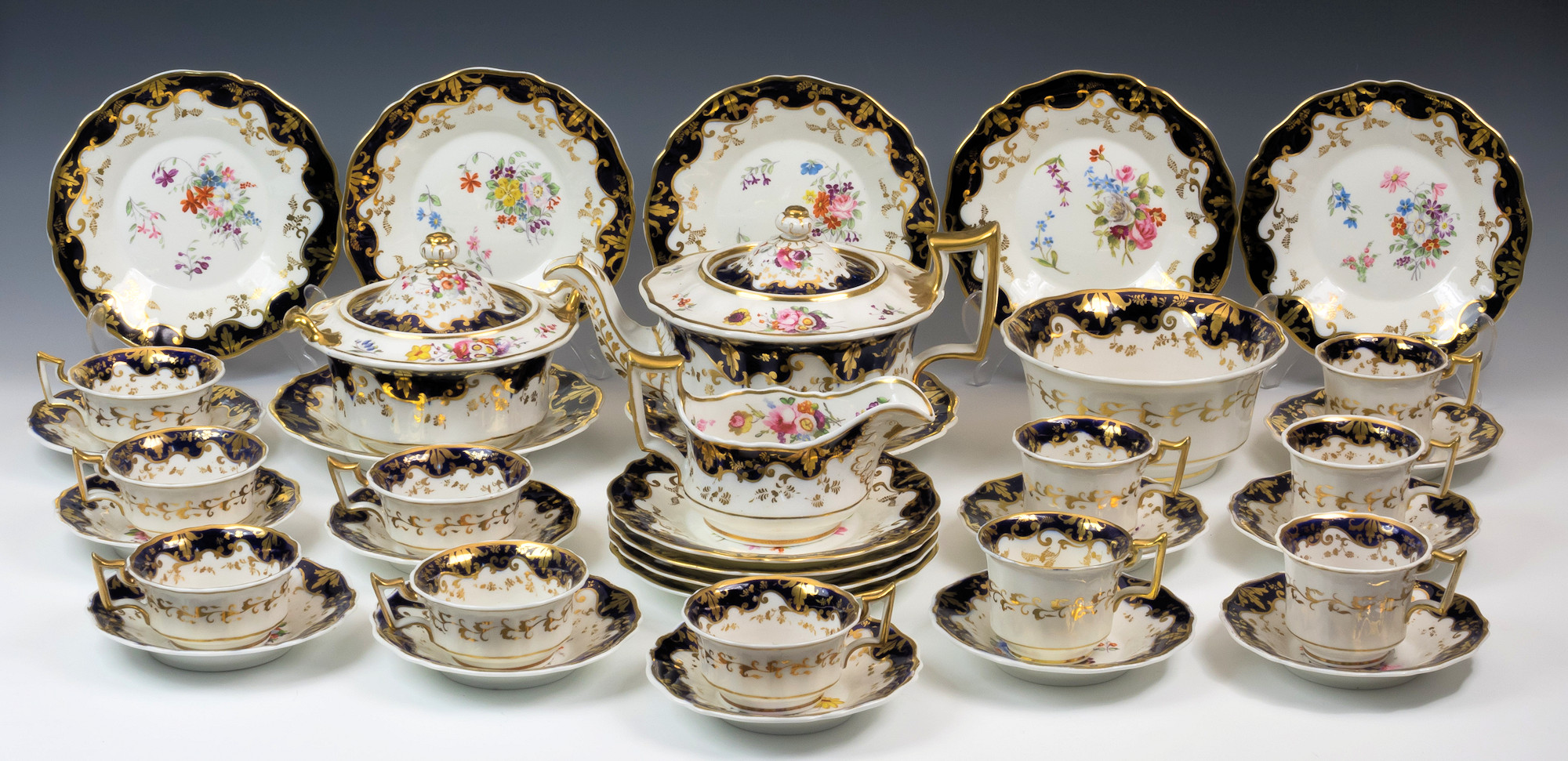 A John Ridgway porcelain full tea service, 19th century, pattern no. 1063, painted with sprays of