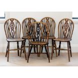 A matched set of five early 19th century beech and elm wheelback Windsor chairs, including one elbow