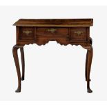 A George II oak provincial lowboy, the moulded top with everted corners, over a central shallow