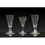 A pair of late 18th century wrythen twist dwarf ale glasses, the conical bowls with wrythen