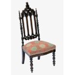 A Victorian faux calamander wood Gothic style nursing chair, the Gothic arched back with foliate
