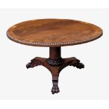 A William IV cross banded mahogany tilt-top breakfast table, the circular top in well figured