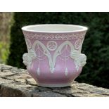 A Victorian pottery pink glazed jardinière, possibly by Minton, waisted form, the exterior with