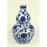 A Chinese blue and white porcelain double gourd vase, 19th century, decorated with flower heads