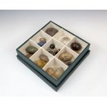 A collection of Victorian carved hardstone eggs and marbles, including thirteen eggs in lalis