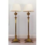 A pair of Victorian copper mounted brass standard lamps, converted from oil lamps, the urn form