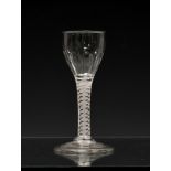 An early 18th century airtwist wine glass, the ogee bowl with petal moulding, on a multi spiral stem