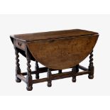 An 18th century oak gateleg dropflap 'ship's' dining table, the oval top over a single frieze drawer