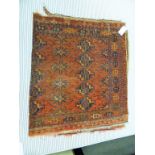 A Tekke Bokhara rug the madder field with rows of medalallions, divided by cruciform motifs,