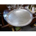 A 19th century silver plated twin handled tray oval, with chased foliate decoration surrounding an