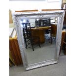 A silver painted bevelled glass mirror