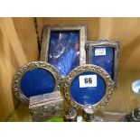 Four silver photo frames together with a miniature silver salt & pepper & a white metal trinket