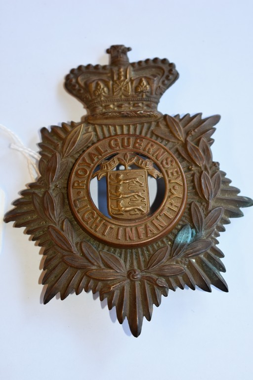 A World War I Royal Guernsey Light Infantry helmet plate.