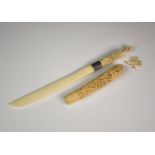 An Indian ivory paper knife early 20th century, straight backed blade with foliate decrated silver