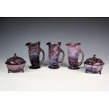 A set of three Heppel & Co purple malachite glass fish water jugs, each standing 7in. (18cm.)