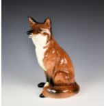 A large Beswick fireside model of a seated fox, model No; 2348, original green sticker to base,