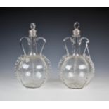 A pair of 19th century Dutch glass decanters, of onion form with applied crimped banding, with