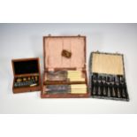 A boxed set of jewellers / gold weights, together with two cased sets of plated cutlery. (3)