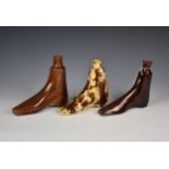 Three novelty 19th century treacle glazed pottery flasks modelled in the form of boots, possibly