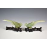 A pair of Chinese carved jade style hardstone Birds of Paradise on stands, 20th century, 6in. (15.