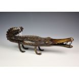 A bronze Bobo Burkina Faso crocodile sculpture, measuring 16«in. (42cm.) nose to tail.