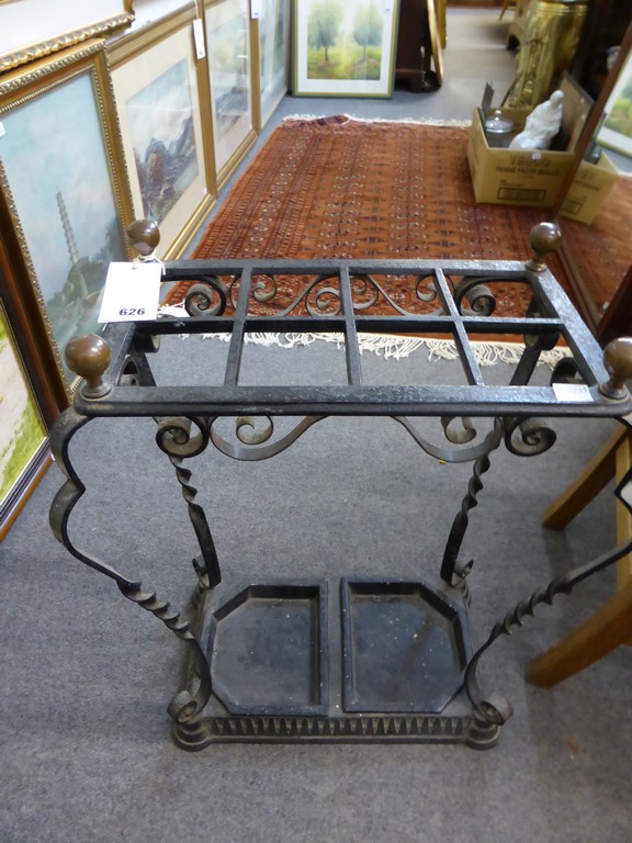 A wrought iron umbrella stand.