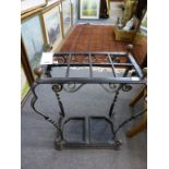 A wrought iron umbrella stand.