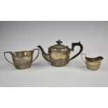 A matched silver three piece bachelor's tea set, Chester, various marks, comprising of teapot,