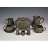 An Art deco period hammered effect pewter tea caddy, together with pewter tankards; cruet set