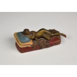 A Bergmann style cold painted bronze of a nude woman laying on a bed, atop a bear skin rug, 1930s,