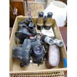 An assortment of binoculars together with a Konica 35mm SLR camera, 35-70 lense and antique
