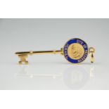 An 18ct gold and enamel City of Nazareth pendent in the form of a key, 5cm. long, in the original