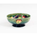 A Walter Moorcroft Leaves and Fruit pattern bowl, late 1940s, the circular bowl on a short,