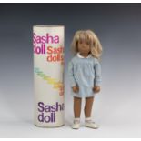 A Gotz Sasha Doll in original box, 1960s, with long blonde hair with dark blue velvet ribbon, blue