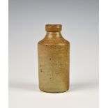 An early 19th century salt glazed stoneware Blacking Bottle made for Jonathan Warren, the front of