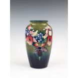 An early Walter Moorcroft Orchid vase, late 1940s, the ovoid form vase with short, waisted neck,