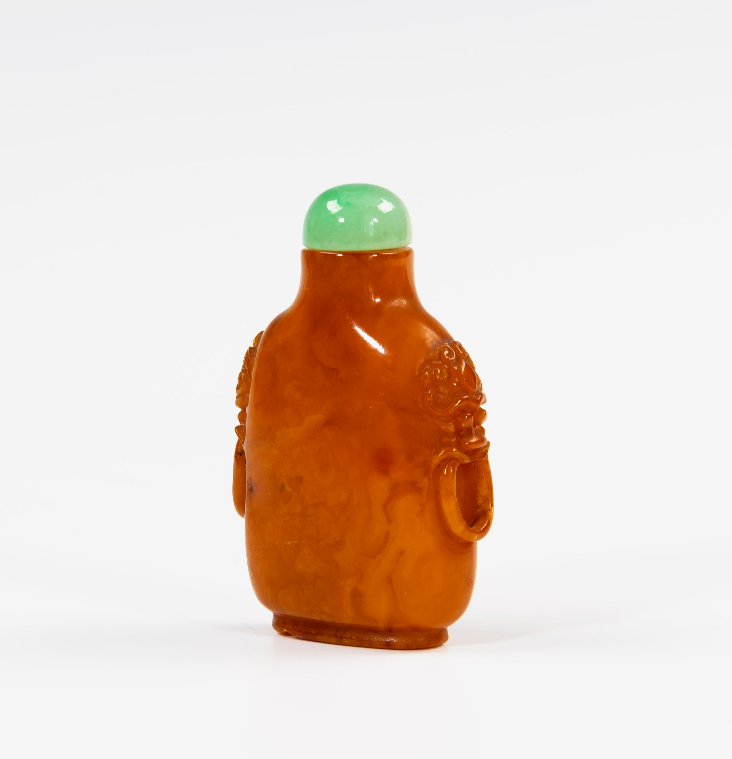 A Chinese egg yolk amber snuff bottle, 18th / 19th century, rounded straight sided form, relief