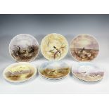 Nine porcelain cabinet plates hand painted with game birds, with scalloped rims, three with Royal