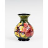 A Moorcroft hibiscus pattern vase, 1950s, baluster form, painted on a graduated olive green to