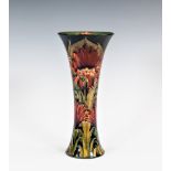 An early William Moorcroft transitional trumpet vase in the Revived Cornflower pattern, manufactured