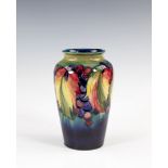 A Moorcroft Leaves and Fruit pattern vase, late 1940s, tapered ovoid form, the decoration on a