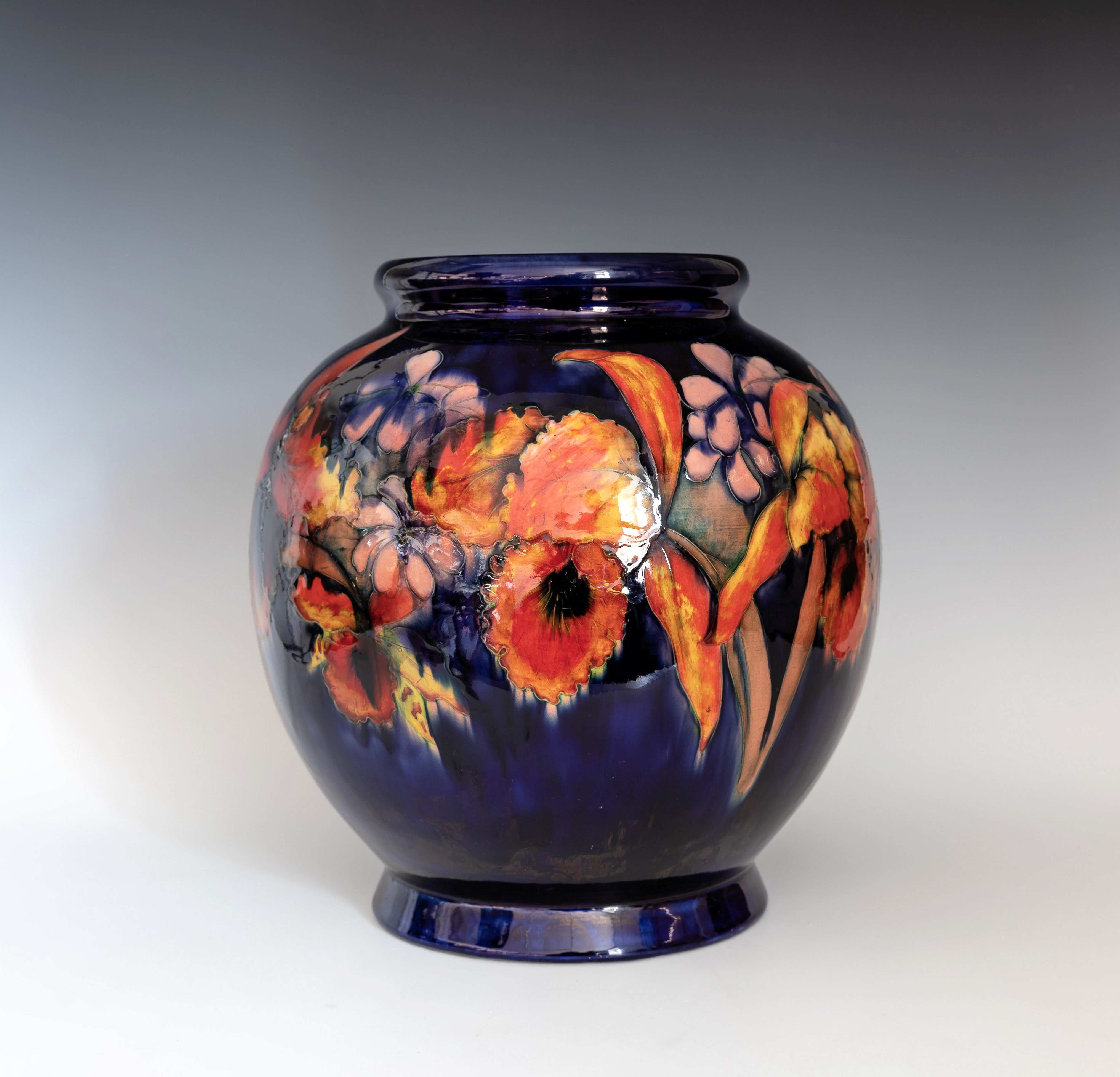 A large Moorcroft Orchid vase, 1930s, the globular form vase with short, slightly flared foot and