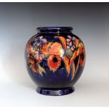 A large Moorcroft Orchid vase, 1930s, the globular form vase with short, slightly flared foot and