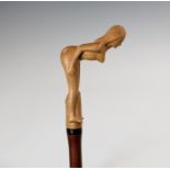 A novelty erotic walking stick, late 20th century, probably Philippines, the slender malacca cane