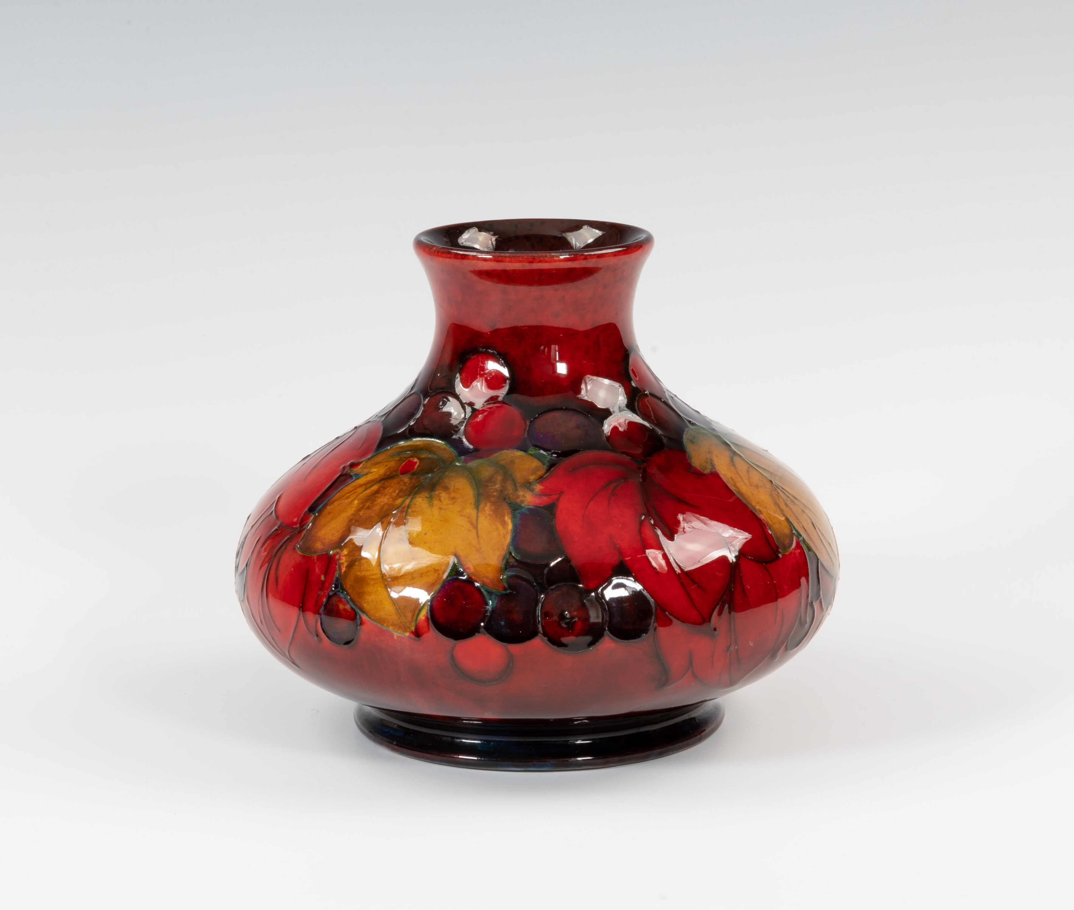 A Moorcroft flambé decorated vase, 1918-26 impressed marks with painted signature, of squat baluster
