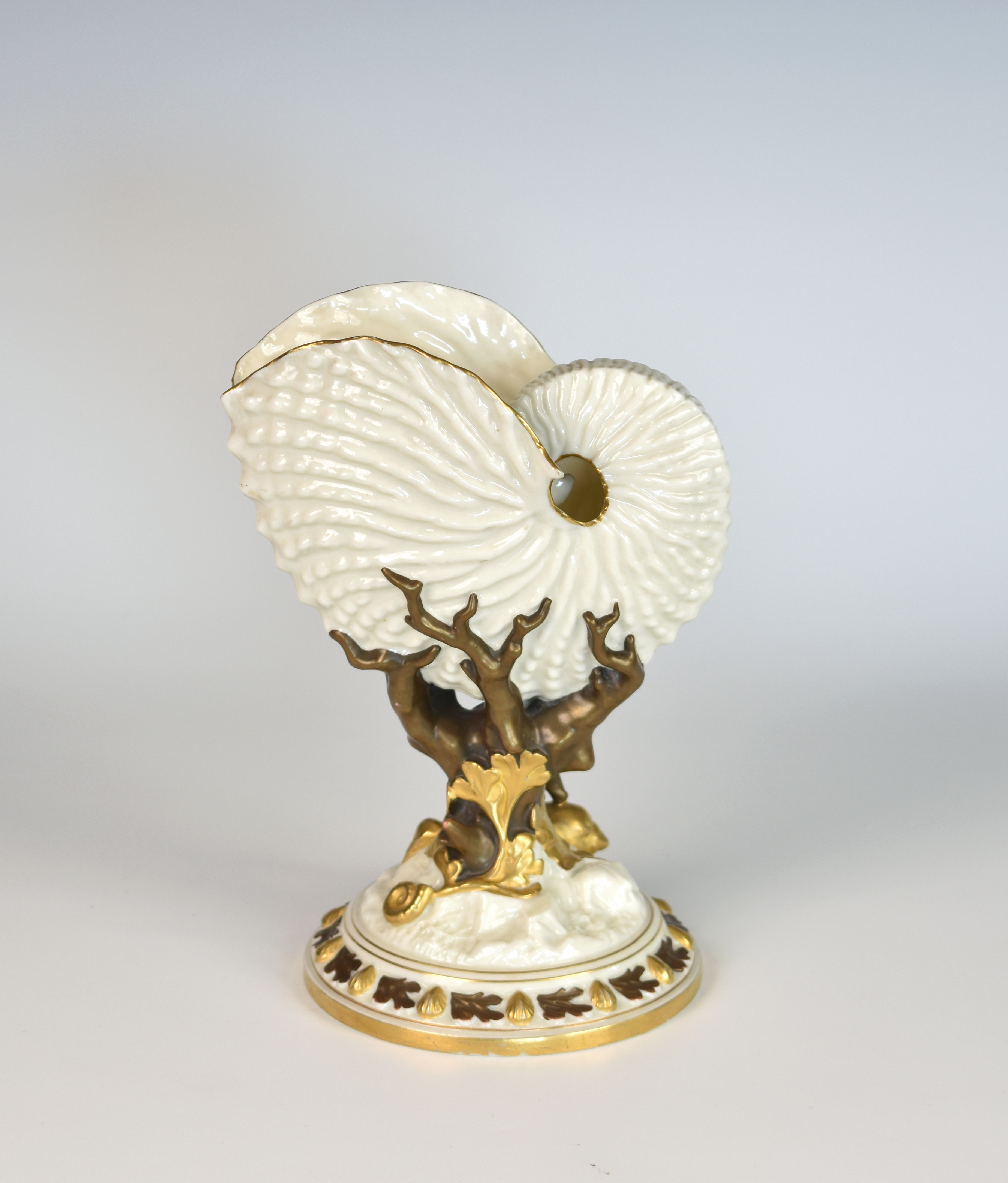 A Royal Worcester nautilus shell vase, impressed and green printed factory marks, the iridescent