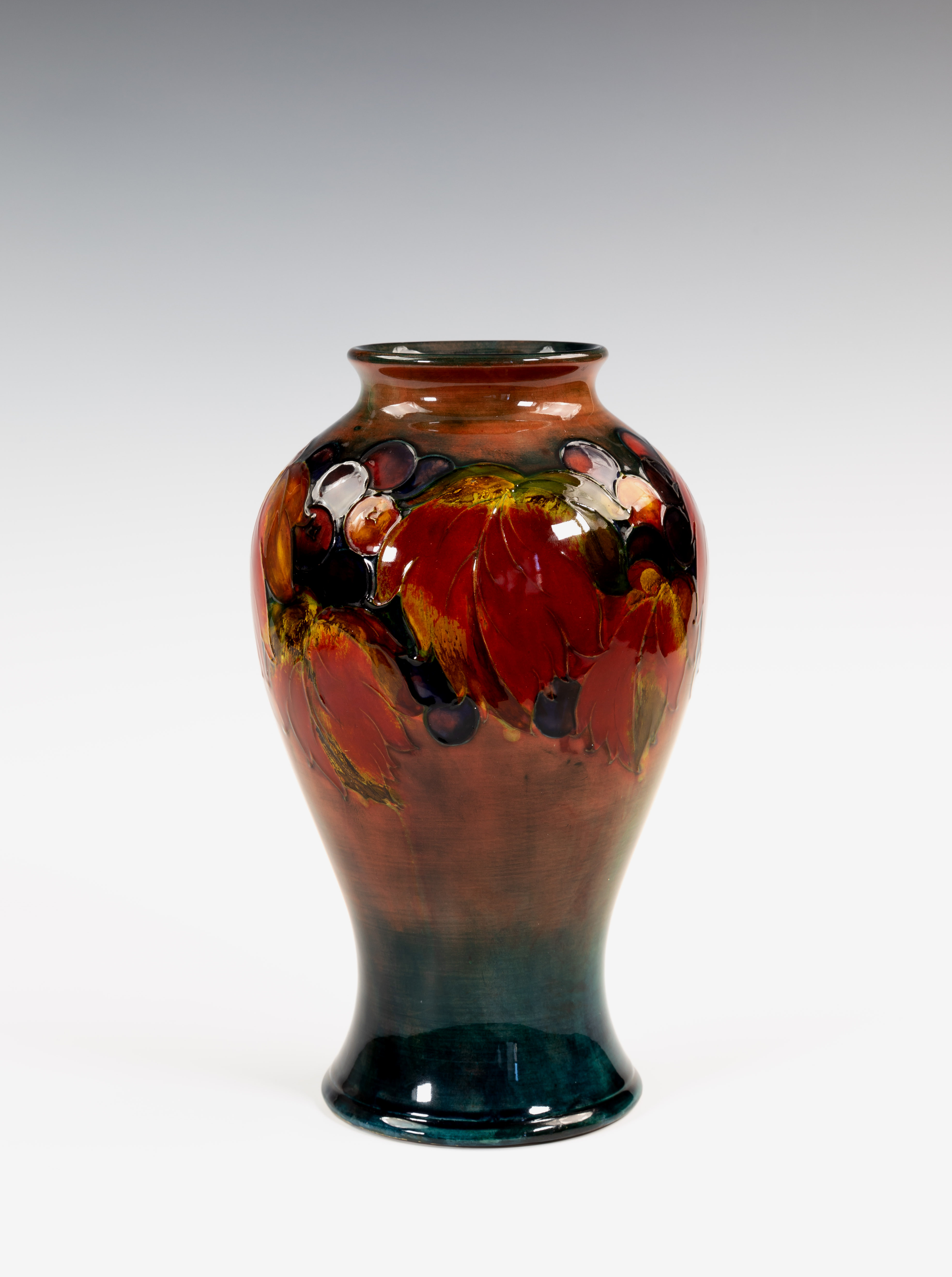 A Moorcroft flambé glazed vase, 1930s, of inverted baluster form, decorated in the Leaves and